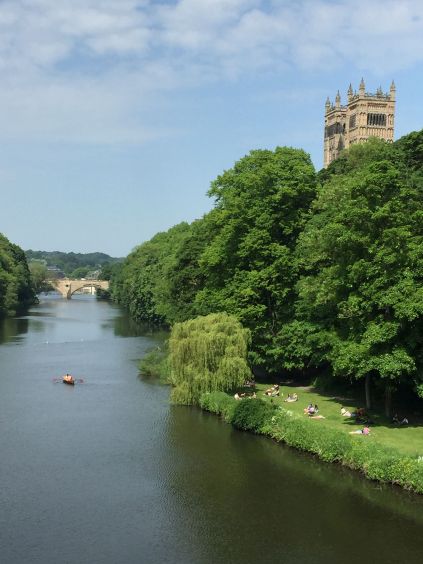 Twin towers of the west front of Durham Cathedral rise above the River Wear in Durham, England